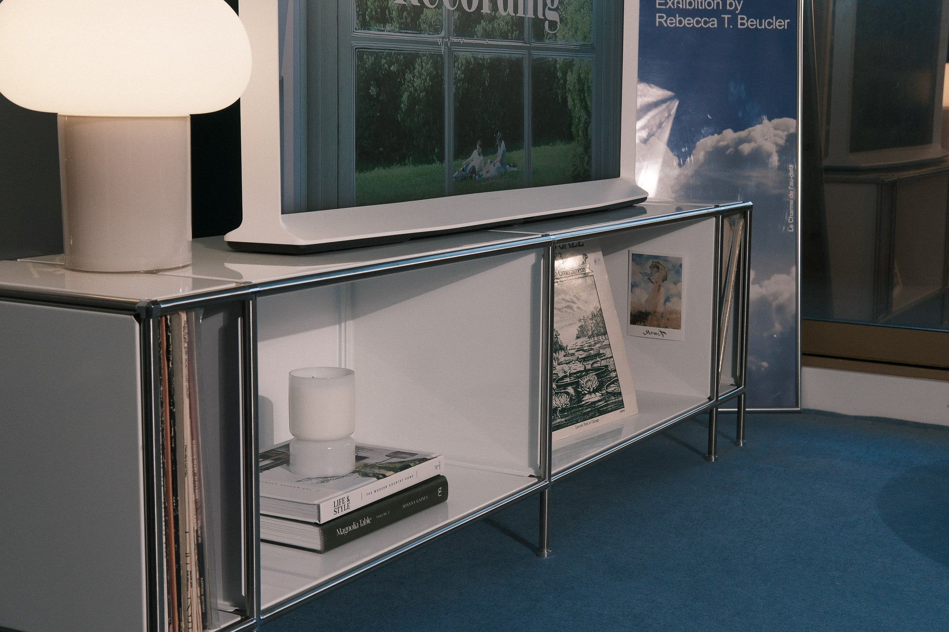 Contemporary TV stand with decor and open shelving.